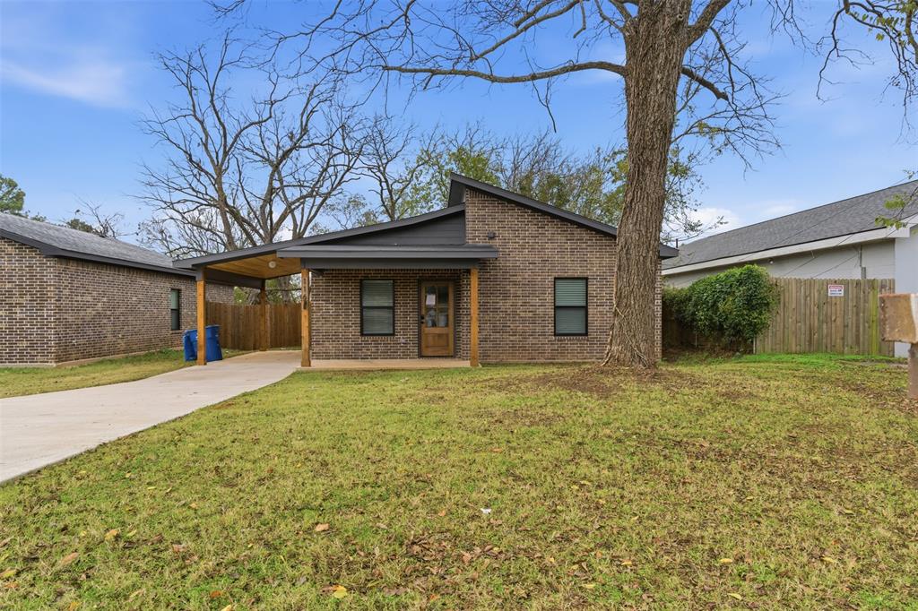 116 Harrison Street Denison, TX 75021 - Photo 25 of 25 Mid-century modern home with brick siding, a carport, concrete driveway, and a patio area