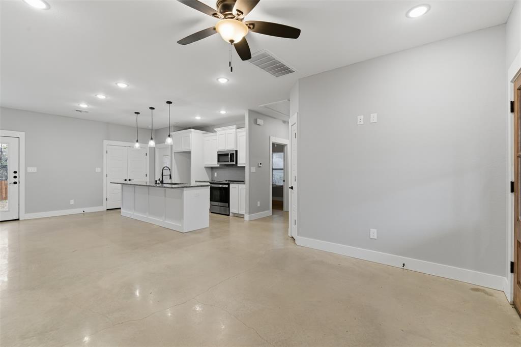 116 Harrison Street Denison, TX 75021 - Photo 4 of 25 Unfurnished living room featuring recessed lighting, ceiling fan, and finished concrete flooring