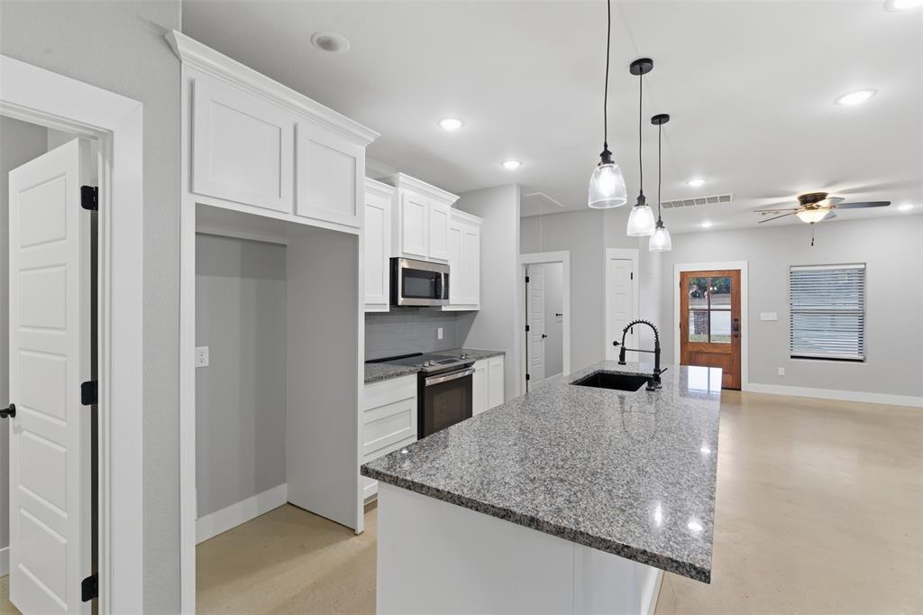 116 Harrison Street Denison, TX 75021 - Photo 8 of 25 Kitchen with dark stone counters, white cabinetry, decorative backsplash, stainless steel appliances, and recessed lighting