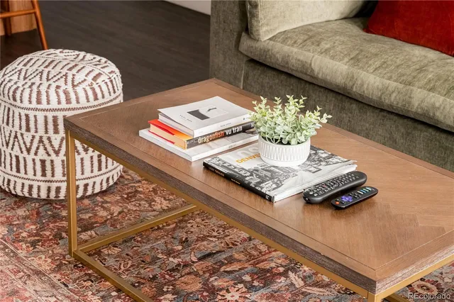 a living room with a rug and a table