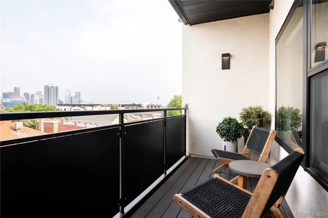 a view of a balcony with chair and wooden floor