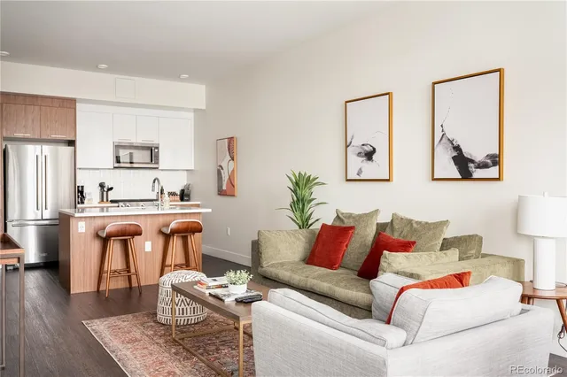 a living room with furniture and kitchen view
