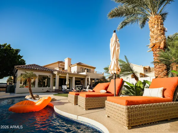 a living room with patio furniture and a floor to ceiling window