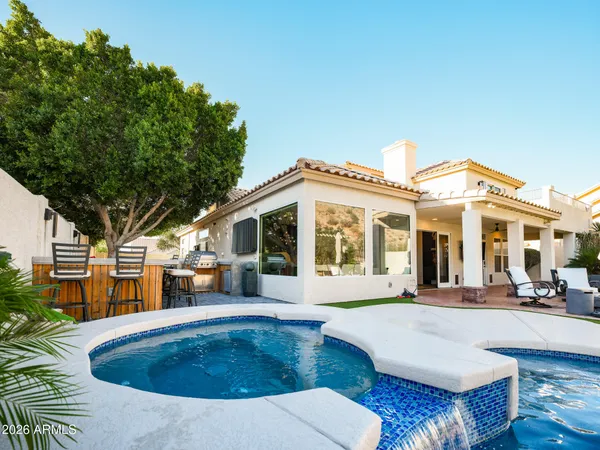 a view of a swimming pool and outdoor seating