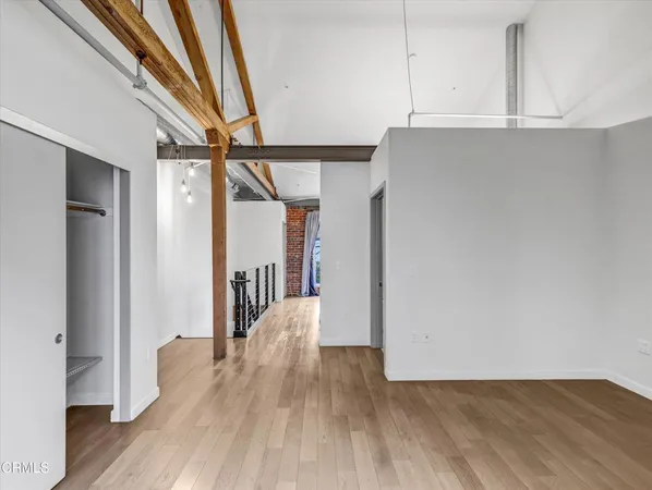 a view of hallway with wooden floor