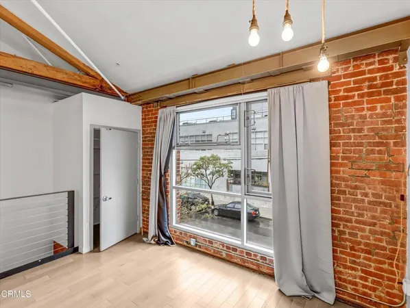 a view of an empty room with glass door