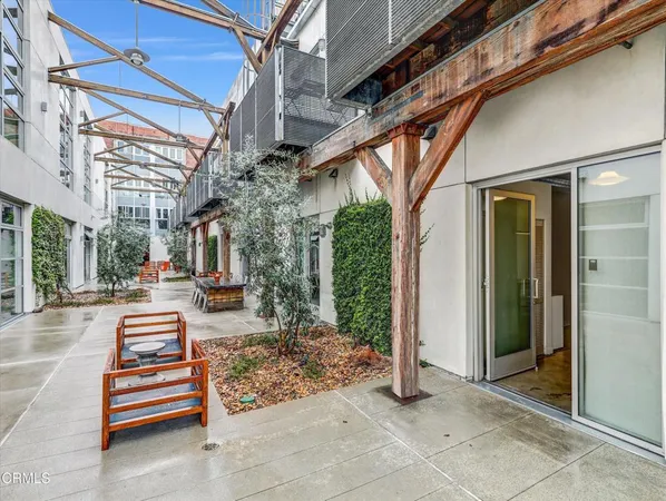 a building outdoor space with patio furniture and potted plants