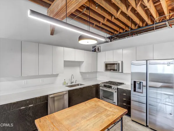 a kitchen with a sink a stove and refrigerator