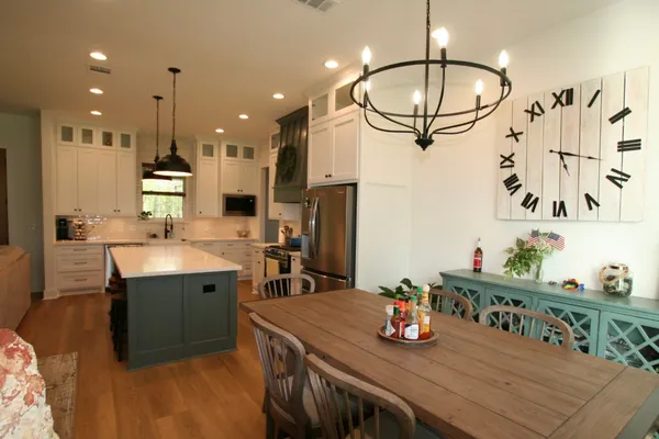 a kitchen with stainless steel appliances granite countertop a sink refrigerator and cabinets