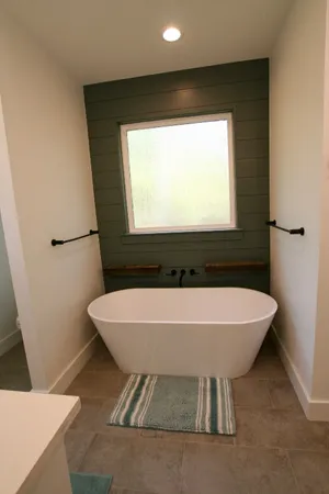 a bath tub sitting in a bathroom next to a toilet