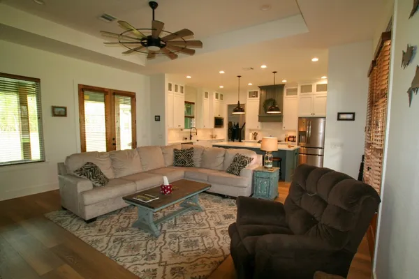 a living room with furniture and a chandelier