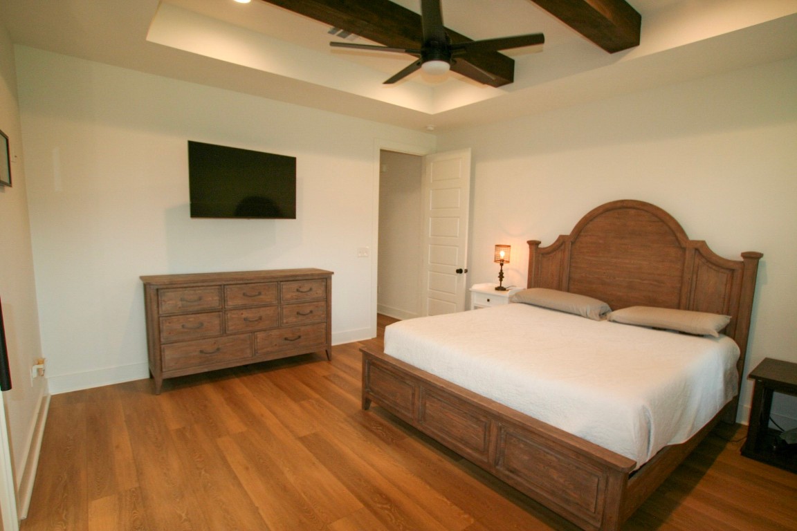 455 East Walton Road Lumberton, TX 77657 - Photo 21 of 31 a bedroom with a bed a dresser and a flat screen tv