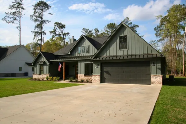 a view of a house with a yard and sitting area
