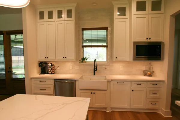 a kitchen with cabinets stainless steel appliances and a sink