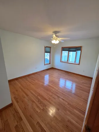 a view of balcony with wooden floor and fence