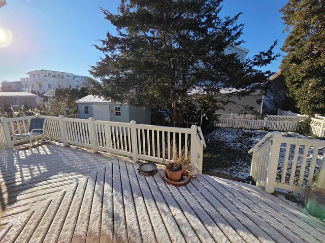 a view of balcony with wooden floor and fence