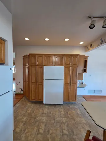 a view of a refrigerator in kitchen