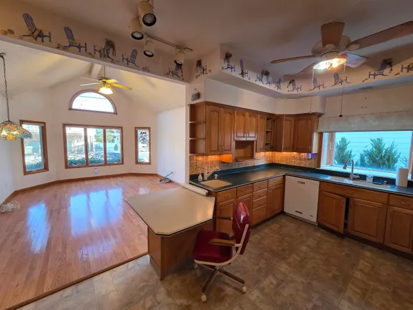 a bathroom with a granite countertop sink a toilet and a mirror