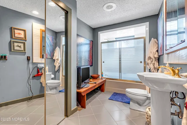 a bathroom with a bathtub toilet and shower