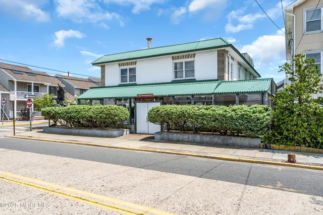 a view of a patio with potted plants and a table and chairs