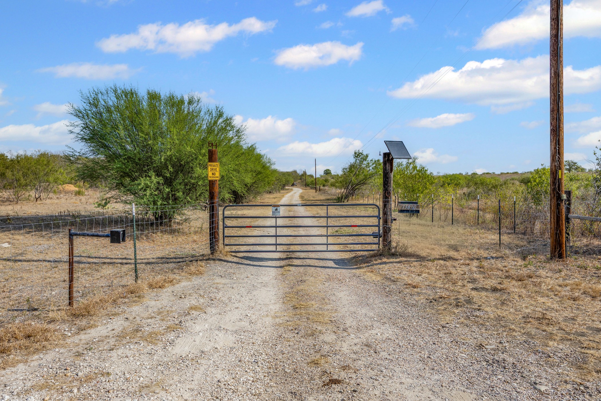 a view of a yard with wooden fence