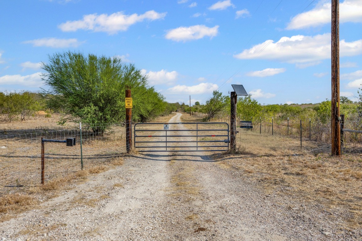 13800 Hokanson Road Del Valle, TX 78617 - Photo 1 of 16 a view of a yard with wooden fence