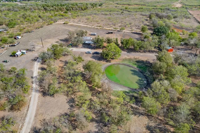 an aerial view of a house with a swimming pool
