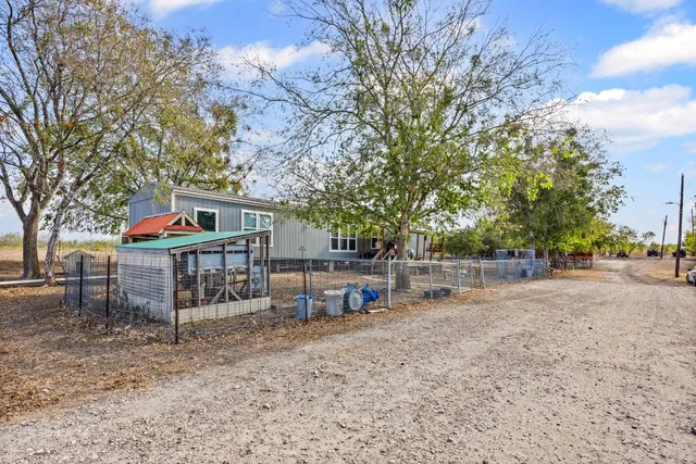 a view of a house with a yard and sitting area