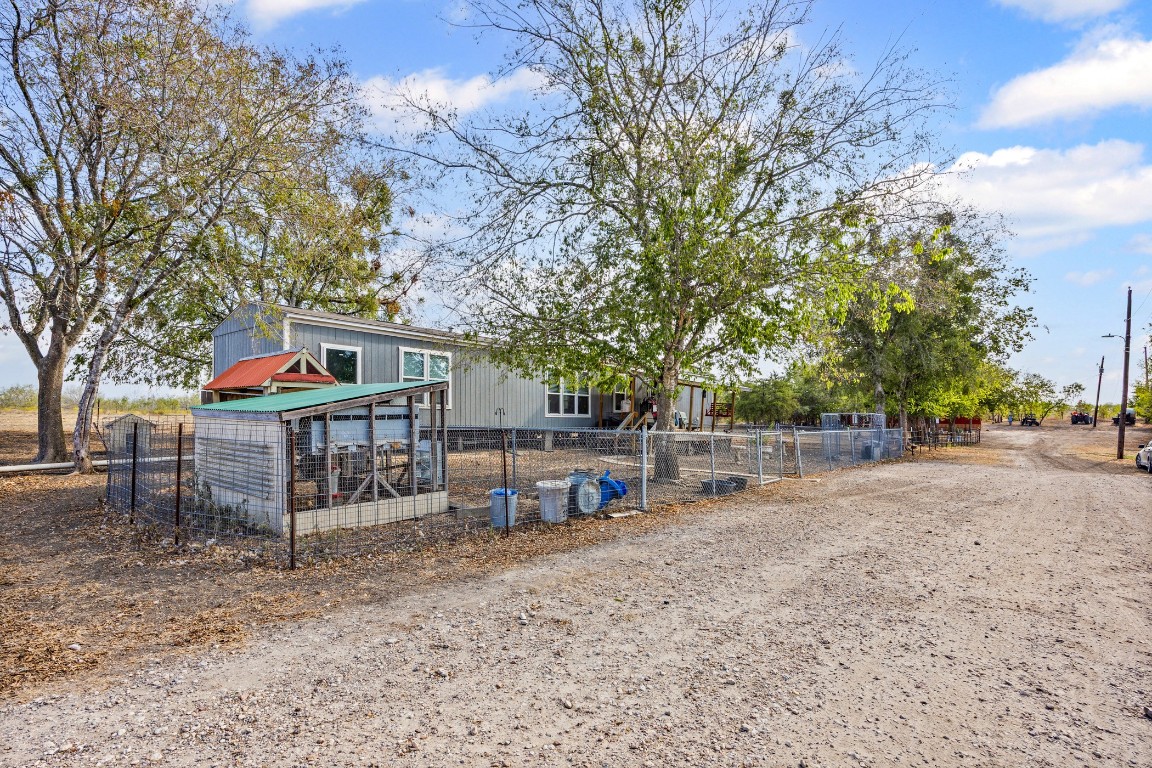 13800 Hokanson Road Del Valle, TX 78617 - Photo 4 of 16 a view of a house with a yard and sitting area