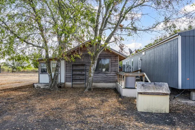 a view of a backyard with patio