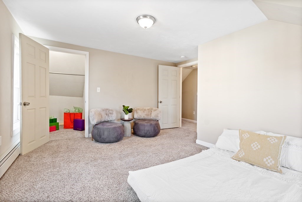 62 Union Street Gardner, MA 01440 - Photo 15 of 24 a bedroom with furniture and a chandelier