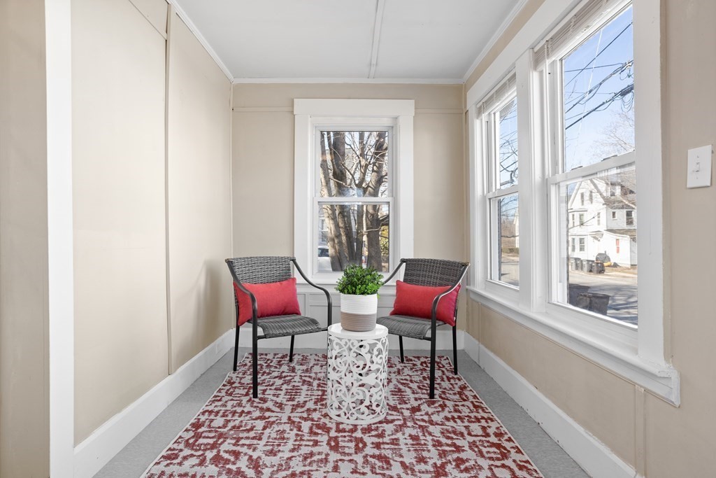 62 Union Street Gardner, MA 01440 - Photo 2 of 24 a blue chair sitting in front of a window