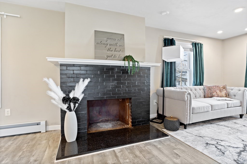 62 Union Street Gardner, MA 01440 - Photo 4 of 24 a living room with furniture a fireplace and a table
