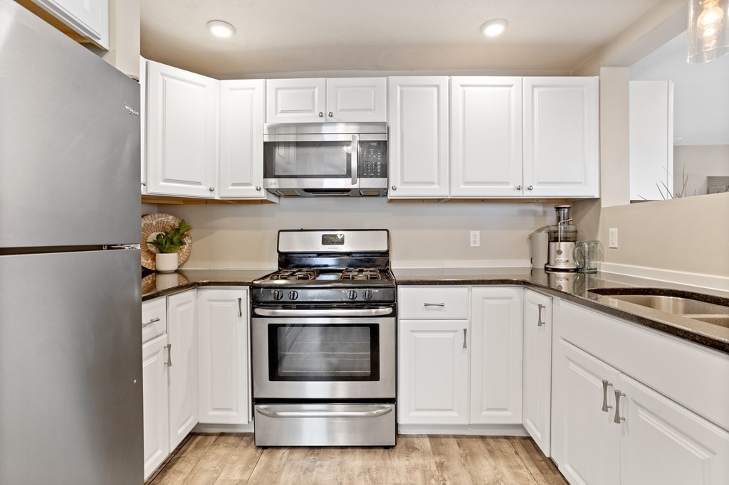 62 Union Street Gardner, MA 01440 - Photo 9 of 24 a kitchen with white cabinets and white appliances