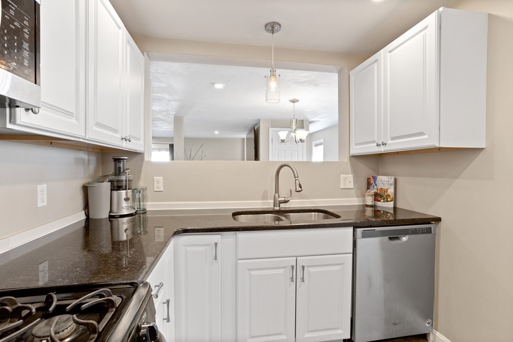 62 Union Street Gardner, MA 01440 - Photo 10 of 24 a kitchen with granite countertop a sink stainless steel appliances and cabinets