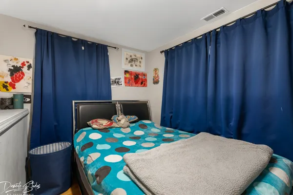 a bedroom with a bed and a table in it