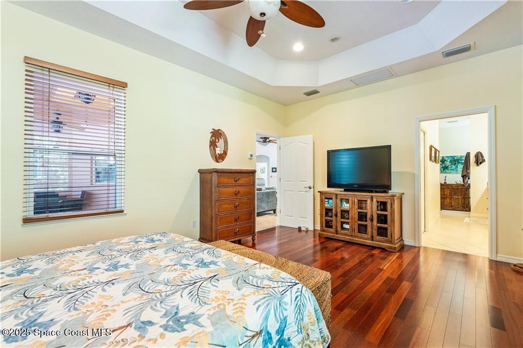 3975 Pepper Tree Street Grant, FL 32949 - Photo 16 of 36 a bedroom with a bed and a flat screen tv