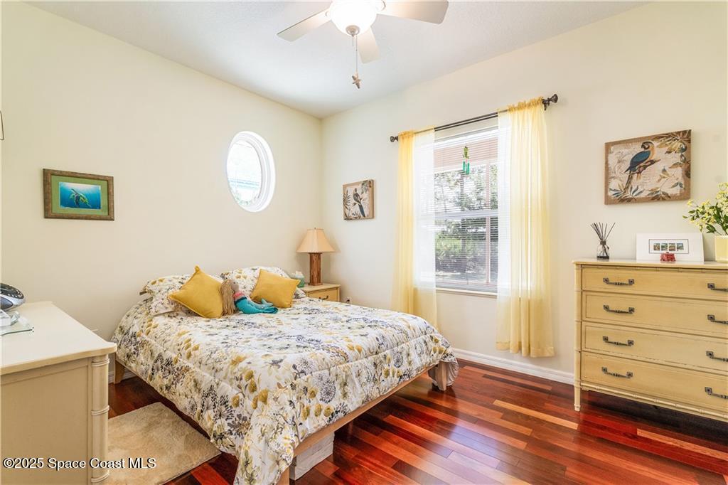 3975 Pepper Tree Street Grant, FL 32949 - Photo 19 of 36 a bedroom with a bed and wooden floor