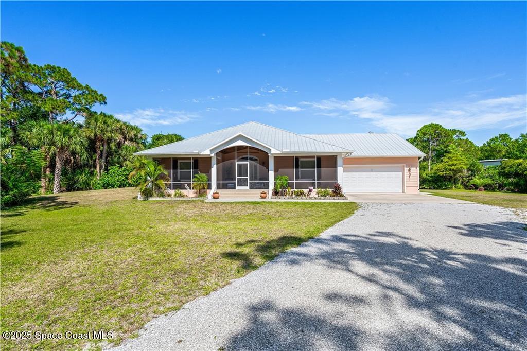 3975 Pepper Tree Street Grant, FL 32949 - Photo 2 of 36 a front view of house with yard and green space