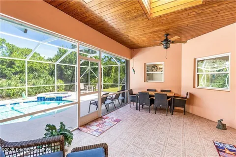 a view of a swimming pool with a porch and yard