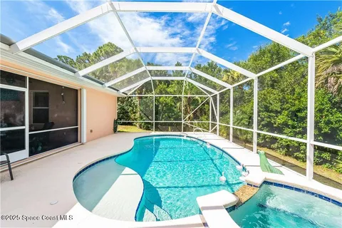 a view of a swimming pool with a patio