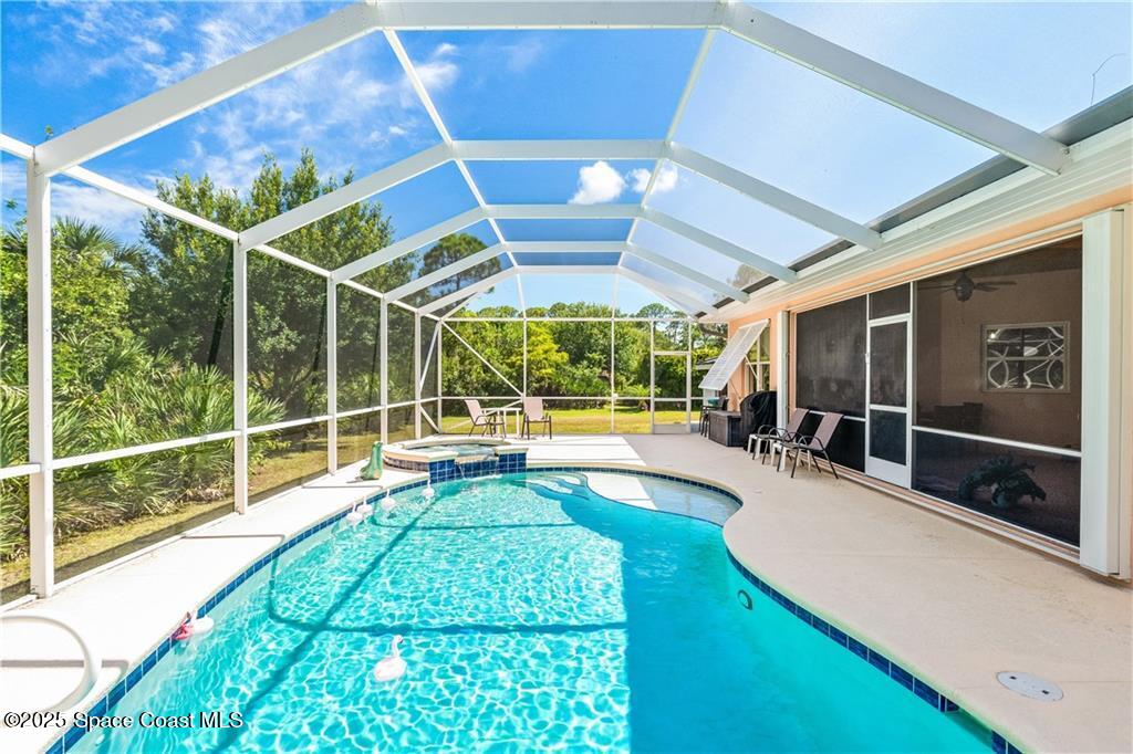 3975 Pepper Tree Street Grant, FL 32949 - Photo 25 of 36 a view of a swimming pool with a patio