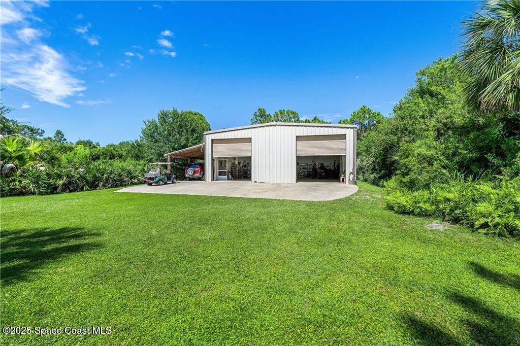 3975 Pepper Tree Street Grant, FL 32949 - Photo 28 of 36 a view of a house with backyard and sitting area