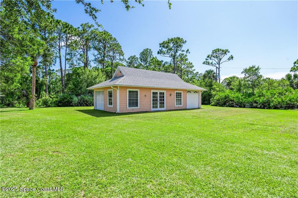 3975 Pepper Tree Street Grant, FL 32949 - Photo 5 of 36 a aerial view of a house next to a yard with big trees