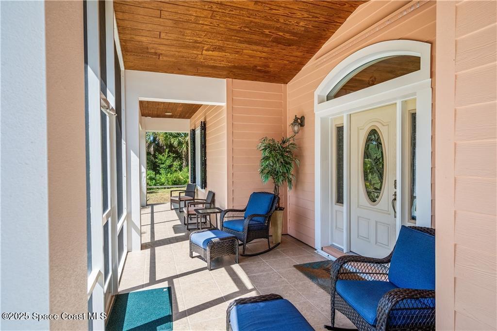 3975 Pepper Tree Street Grant, FL 32949 - Photo 6 of 36 a living room with furniture and a window