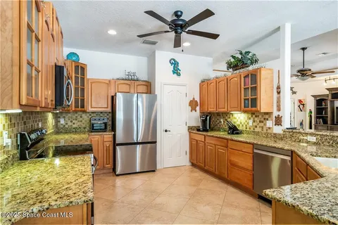 a large kitchen with cabinets and chairs