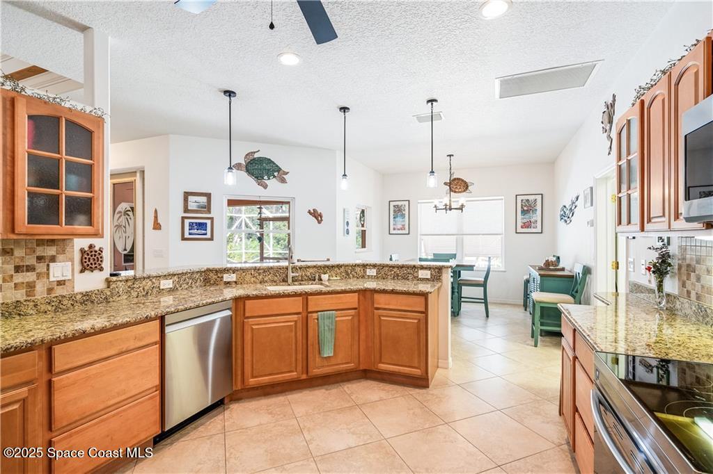 3975 Pepper Tree Street Grant, FL 32949 - Photo 10 of 36 a large kitchen with cabinets and chairs