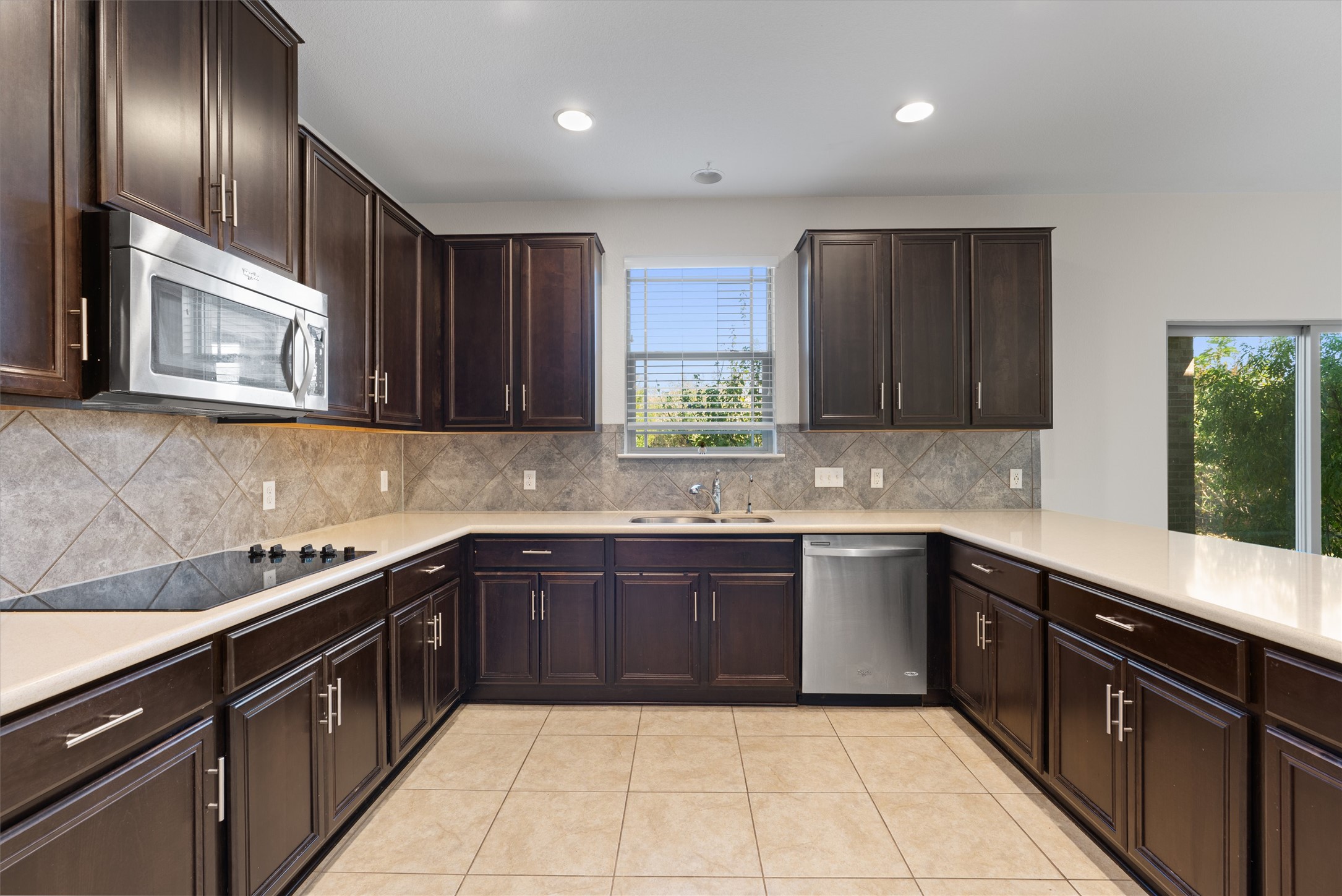 804 Water Hyacinth Loop Leander, TX 78641 - Photo 11 of 37 a kitchen with stainless steel appliances granite countertop wooden cabinets a sink and dishwasher