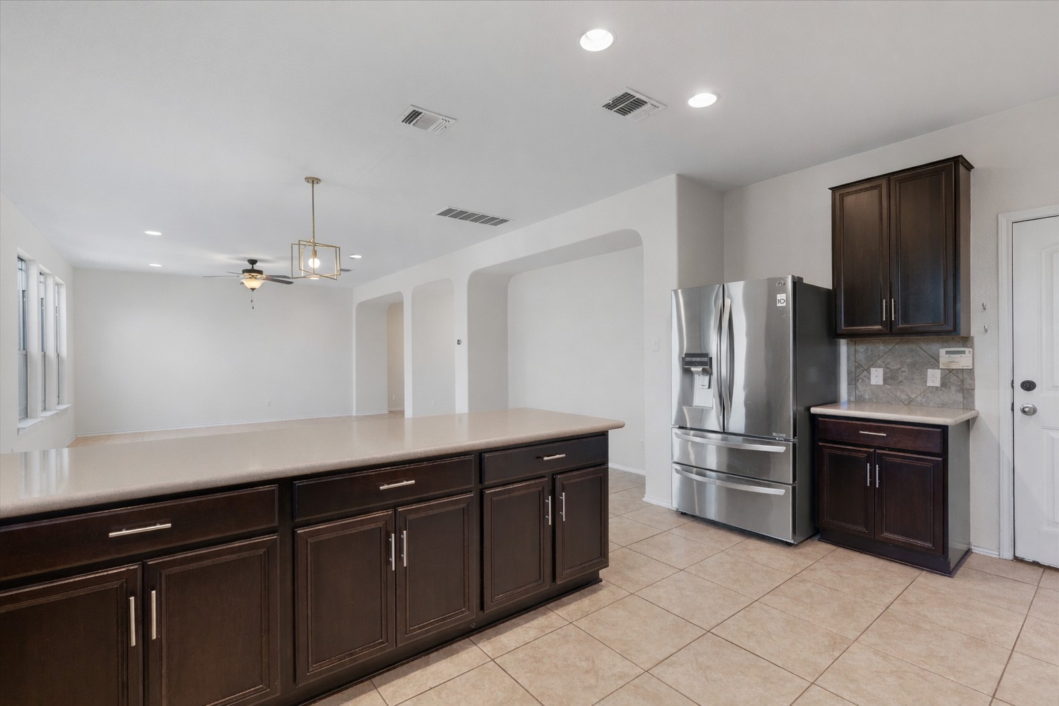 804 Water Hyacinth Loop Leander, TX 78641 - Photo 13 of 37 a kitchen with stainless steel appliances granite countertop a refrigerator and a sink