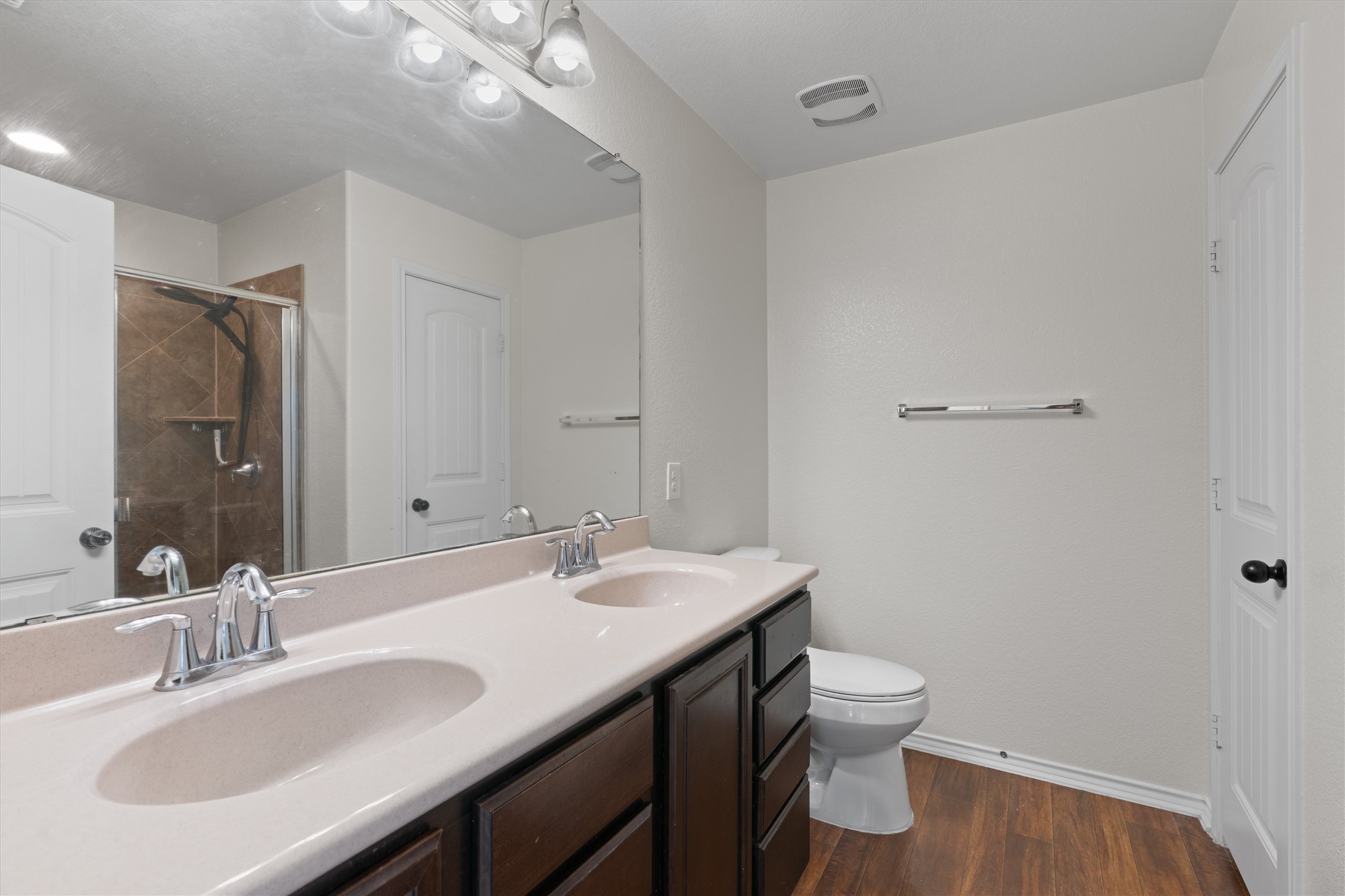 804 Water Hyacinth Loop Leander, TX 78641 - Photo 19 of 37 a bathroom with a granite countertop sink a toilet and a mirror